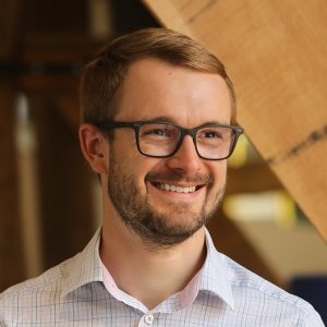 Smiling medical device consultant at Team Consulting, showcasing expertise in medical technology design and development.