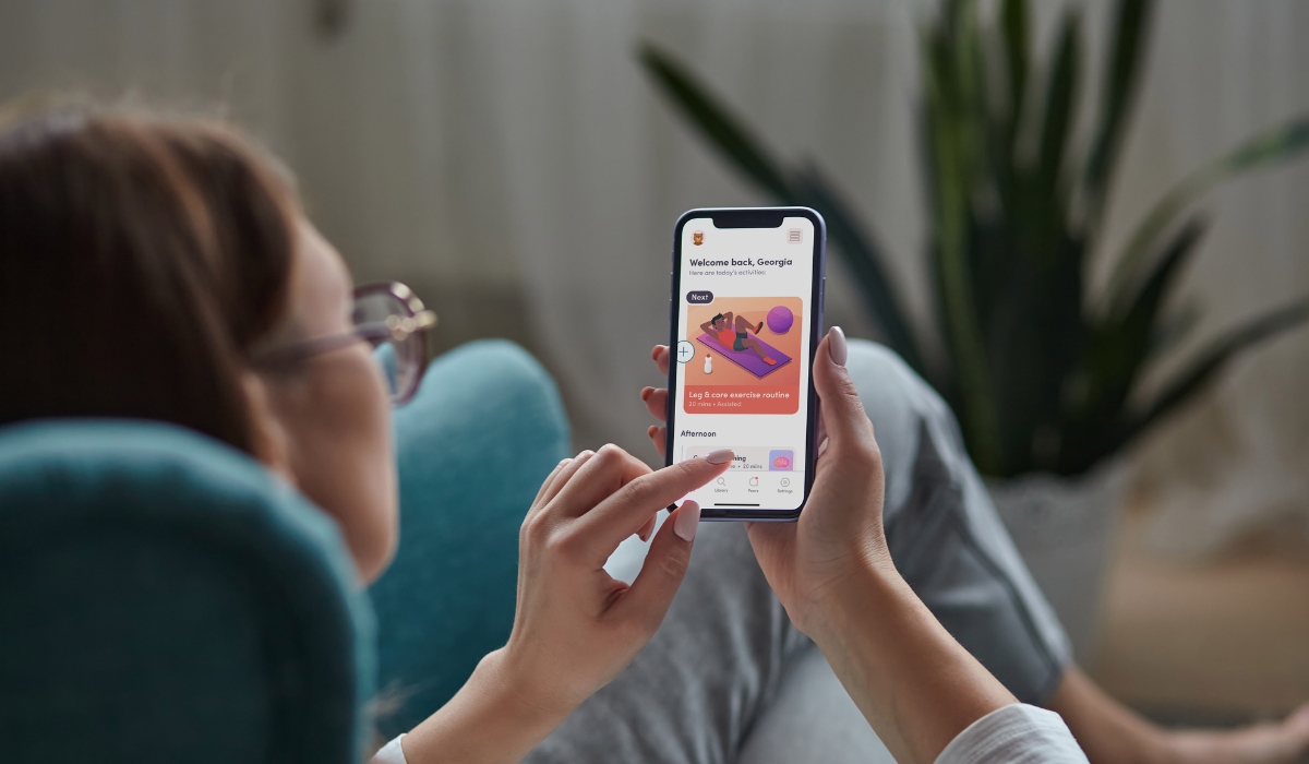 Woman at home using digital health device