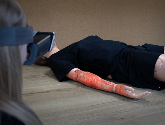 Woman with augmented reality headset for burns training