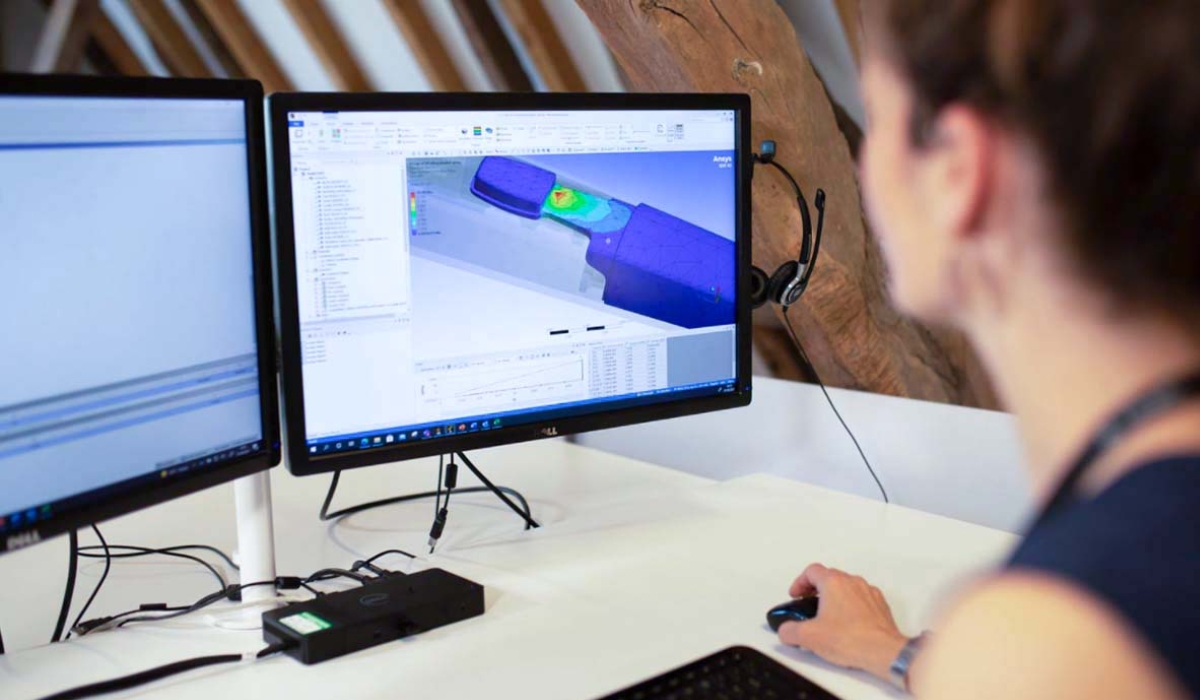Image of a woman with an engineering model on a computer