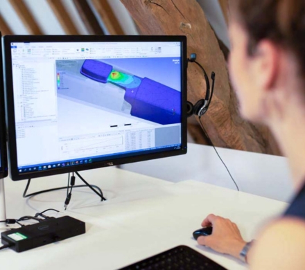 Image of a woman with an engineering model on a computer