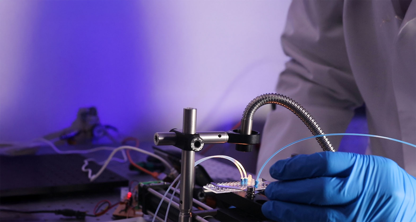 Banner Gloved hands interacting with cell sorting prototype rig