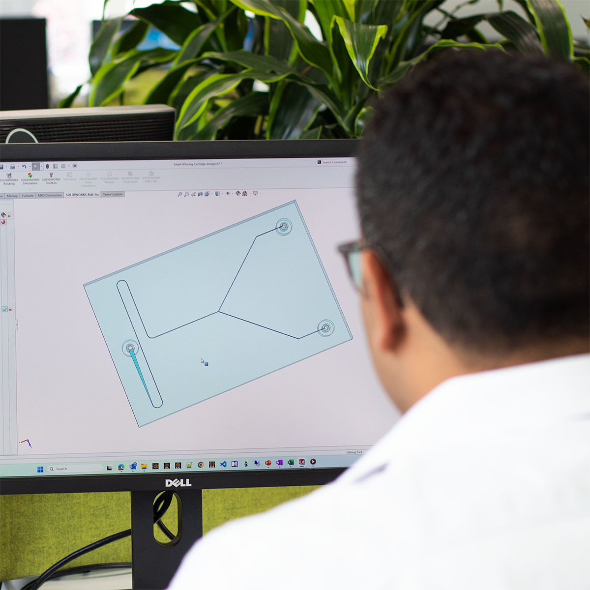 Man at computer working on microfluidic CAD