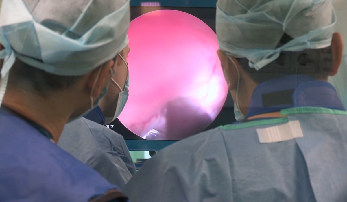 Two surgeons looking at a laparoscope