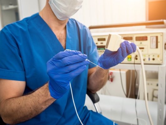 Surgeon preparing for a radio-frequency ablation procedure with small needle/electrode