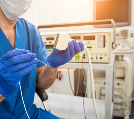 Surgeon preparing for a radio-frequency ablation procedure with small needle/electrode