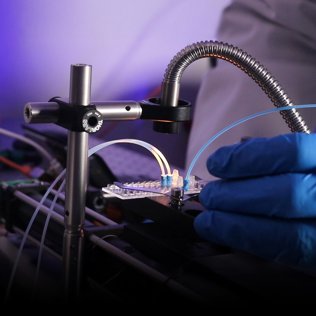 Gloved hands interacting with cell sorting prototype rig
