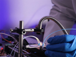 explore Gloved hands interacting with cell sorting prototype rig